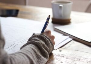 someone handwriting notes with a pen